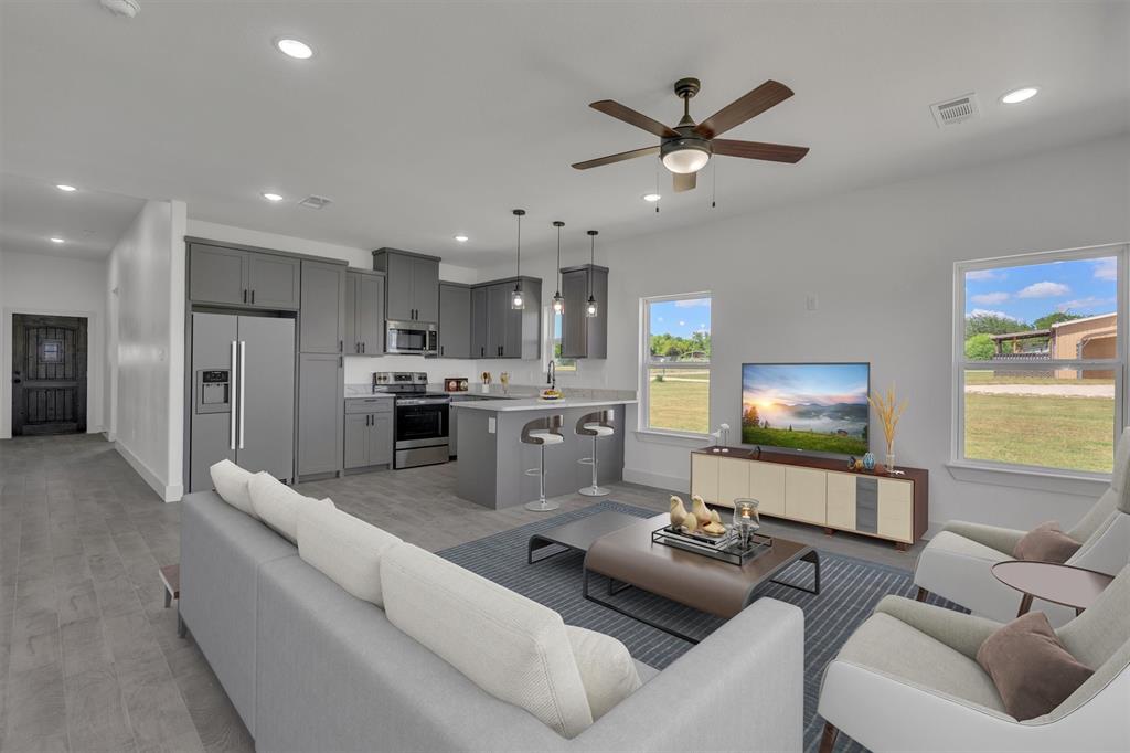 a living room with furniture and kitchen view