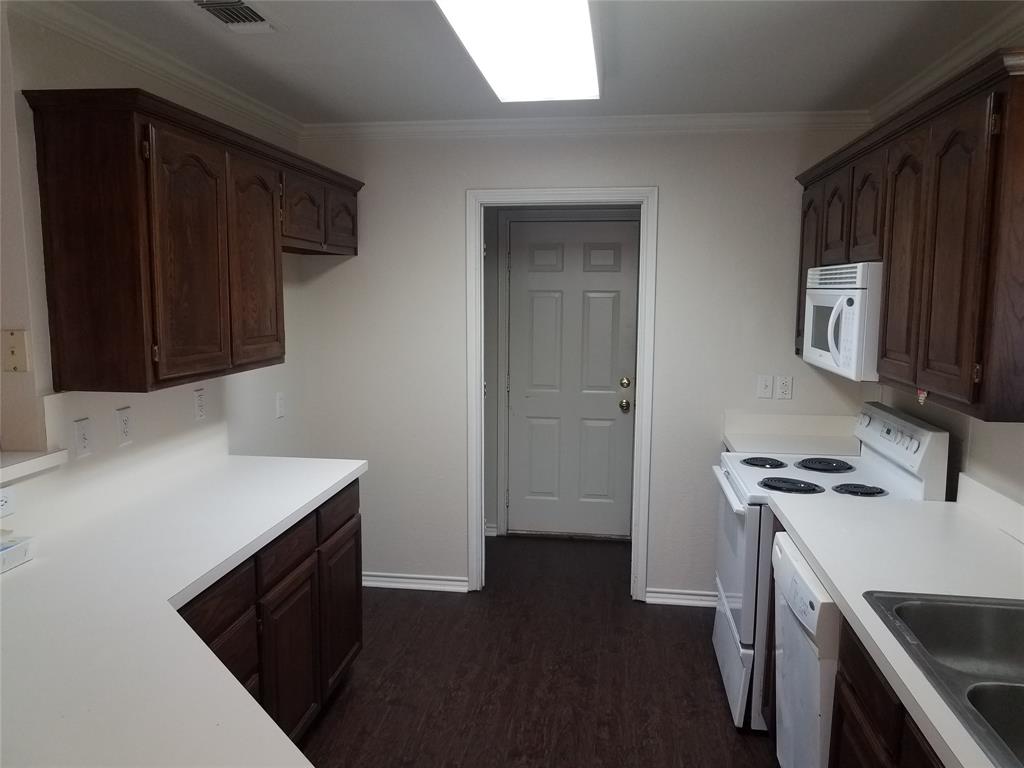 a kitchen with a stove and a microwave