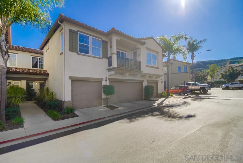 a view of a house with a yard and garage