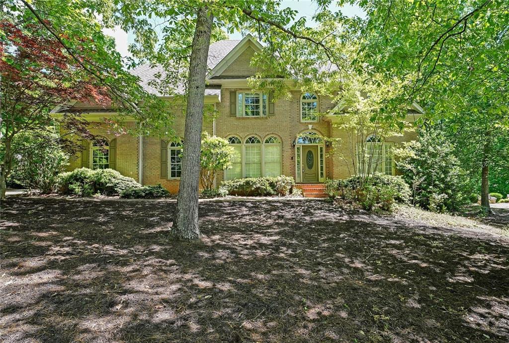 front view of a house with a tree