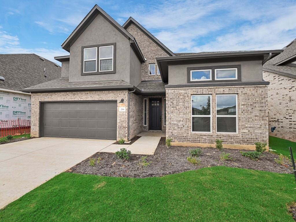 a front view of a house with a yard and garage