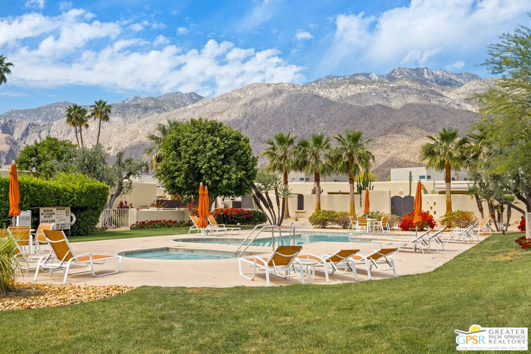 a view of a swimming pool with an outdoor seating