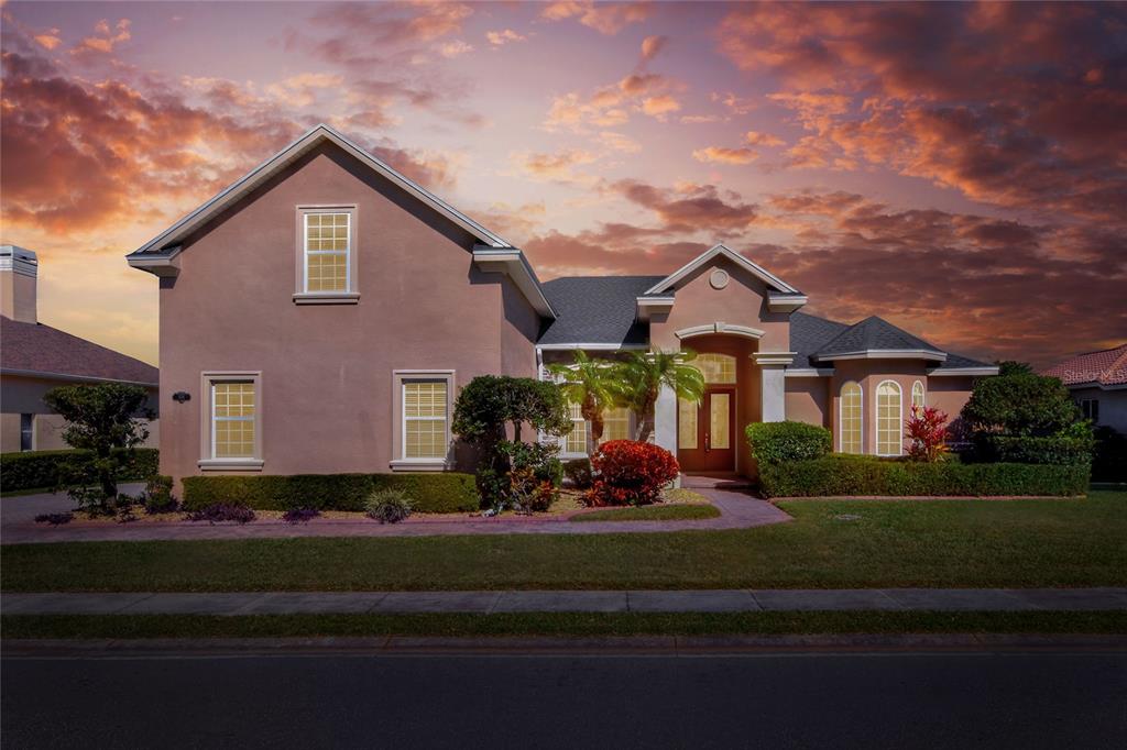 a front view of a house with a garden