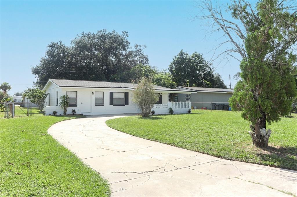 a front view of house with yard and green space