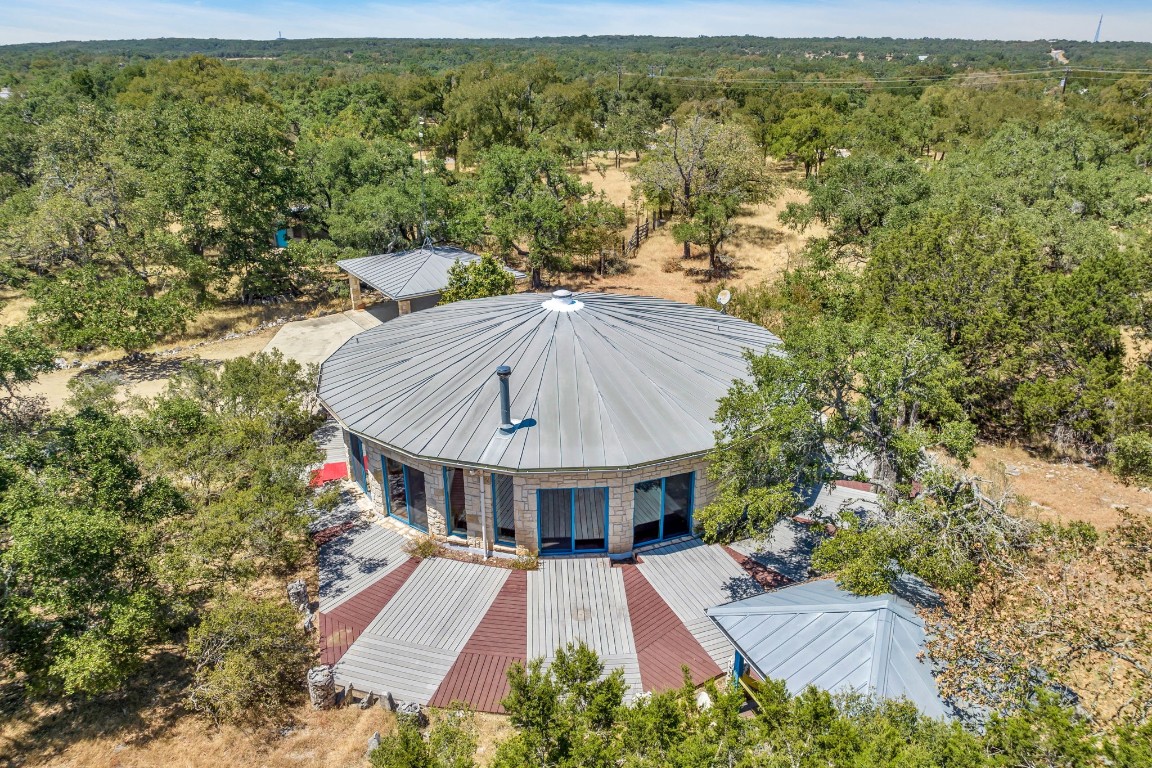 an aerial view of a house with swimming pool garden and patio