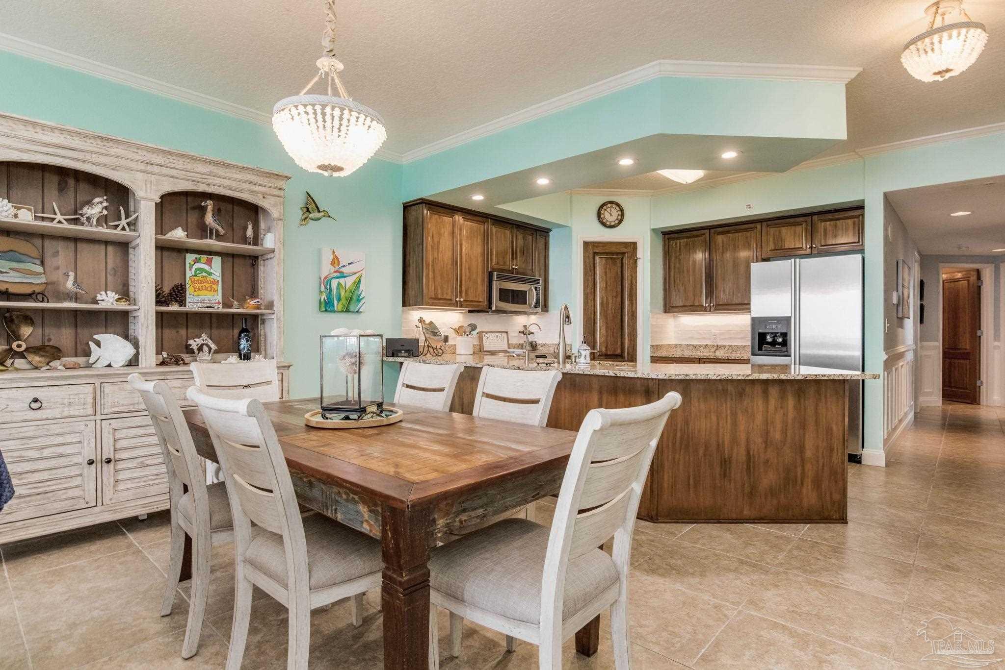 a view of a dining room with furniture and a kitchen