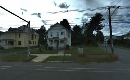 a view of house with a yard