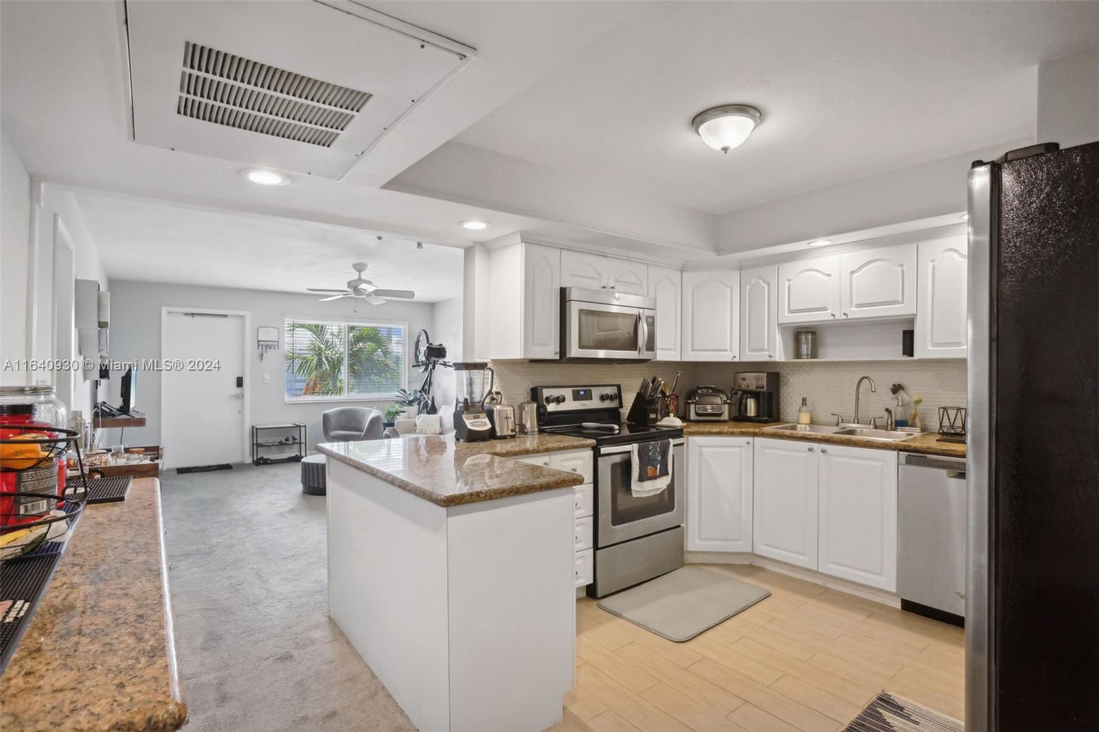 a kitchen with counter top space a sink cabinets and appliances