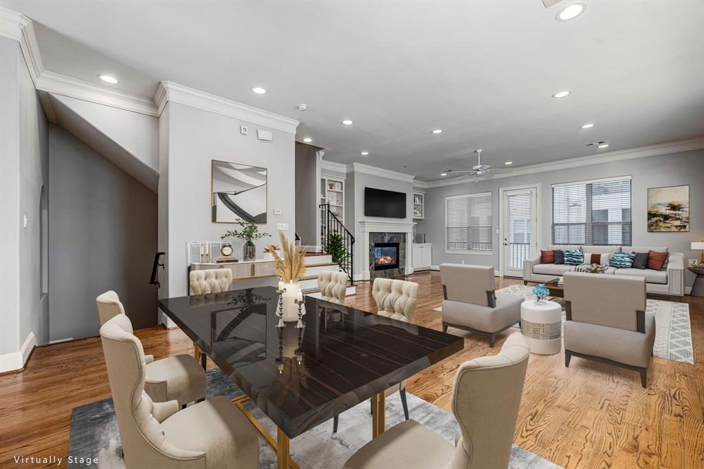 a living room with furniture kitchen view and a wooden floor