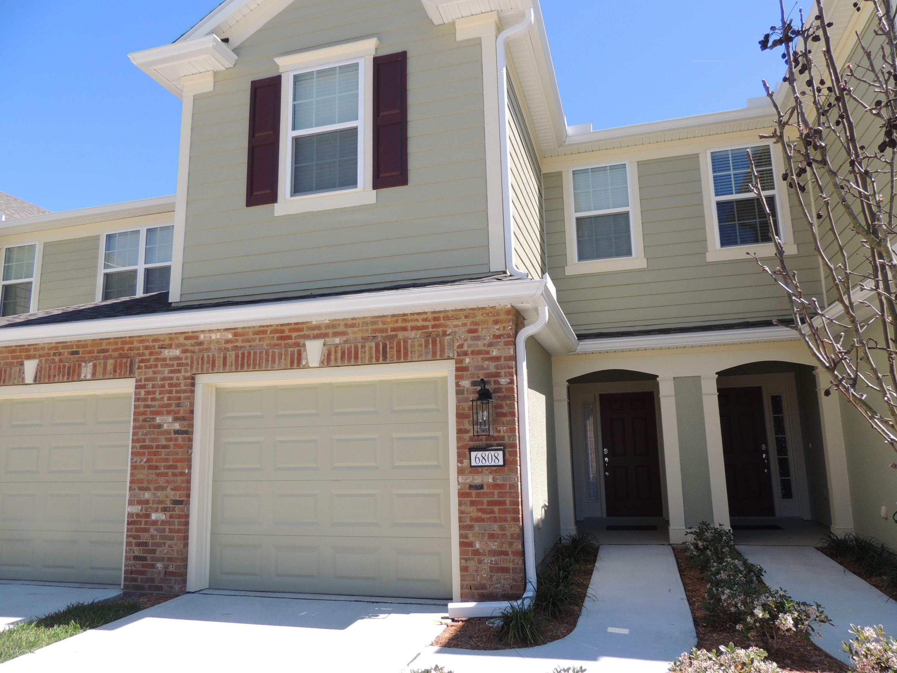 a front view of a house with a garage