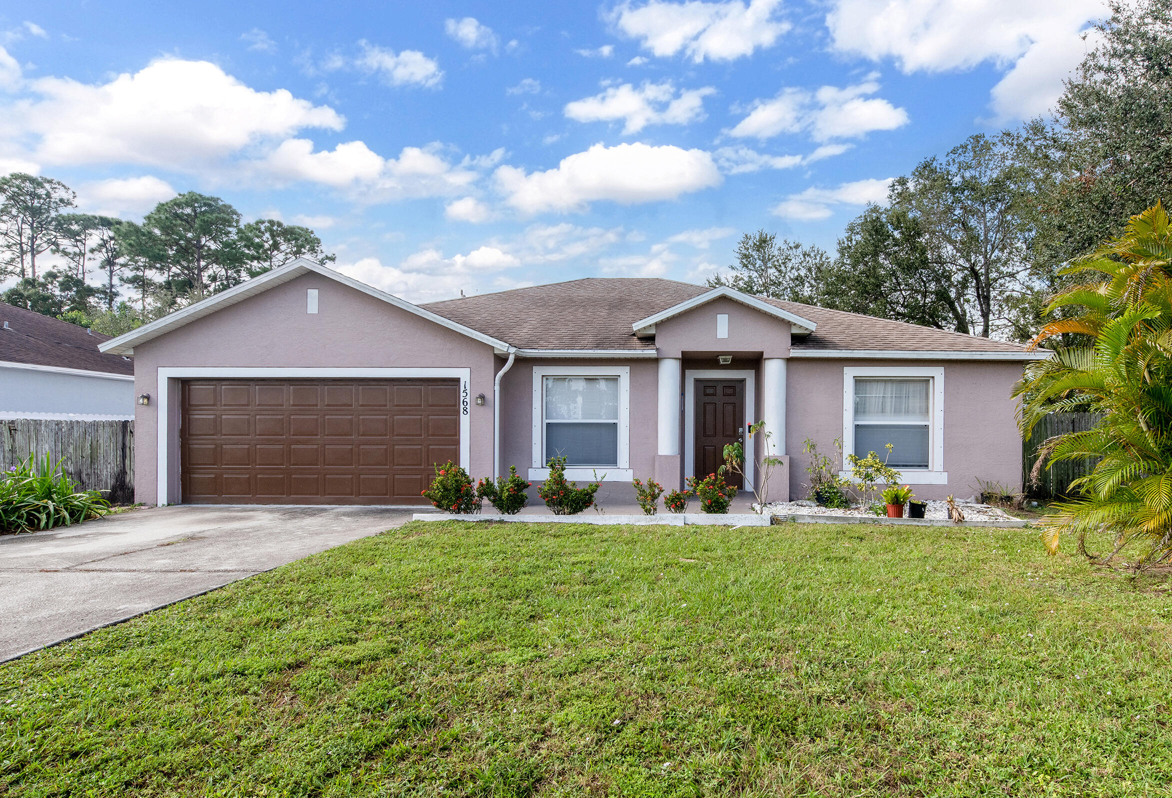 a front view of house with yard outdoor seating and garage