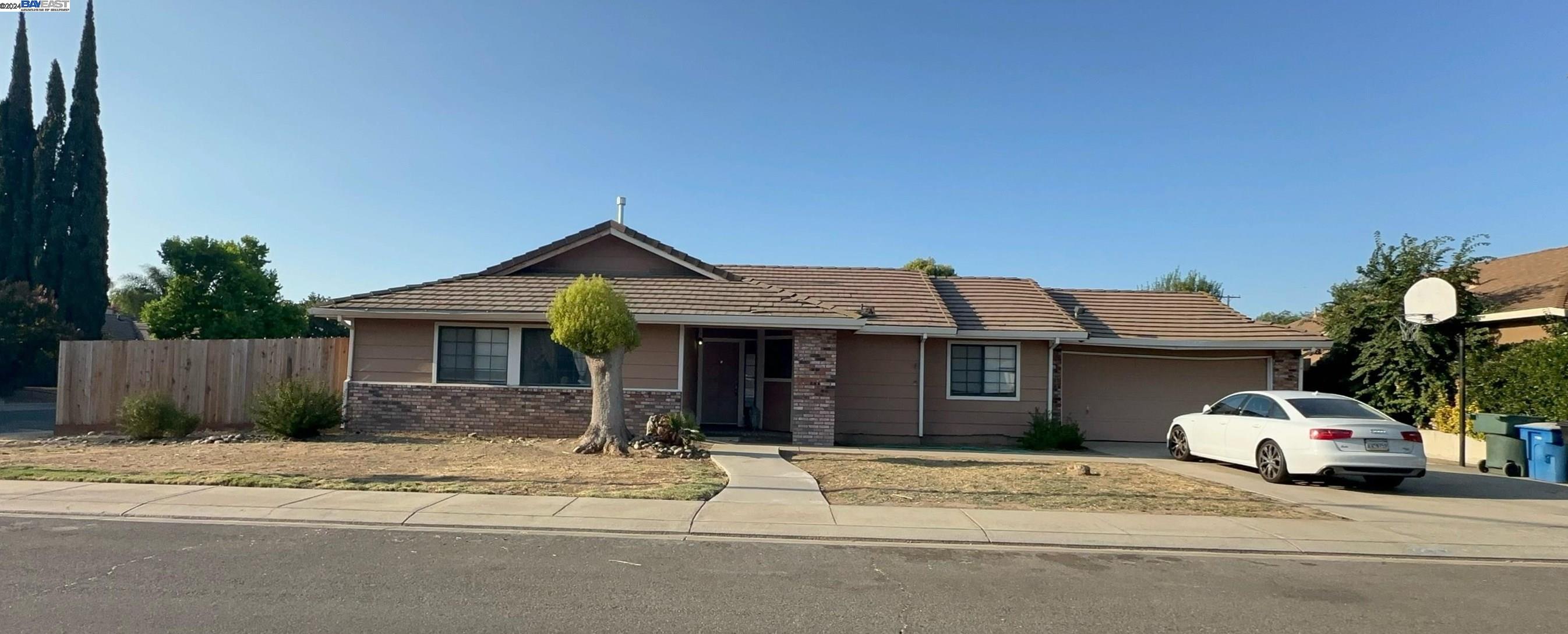 a view of a house with a yard and garage