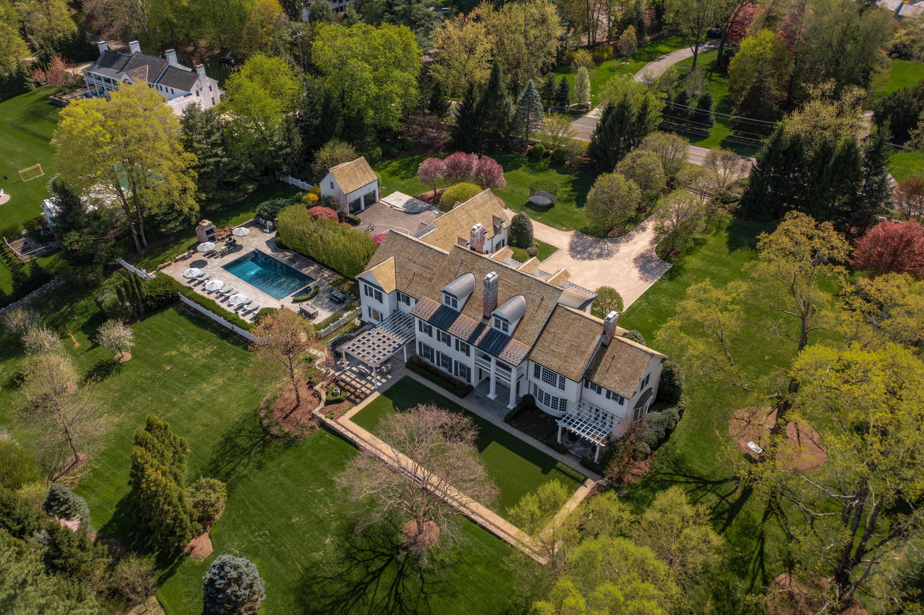 an aerial view of a house with a garden and swimming pool