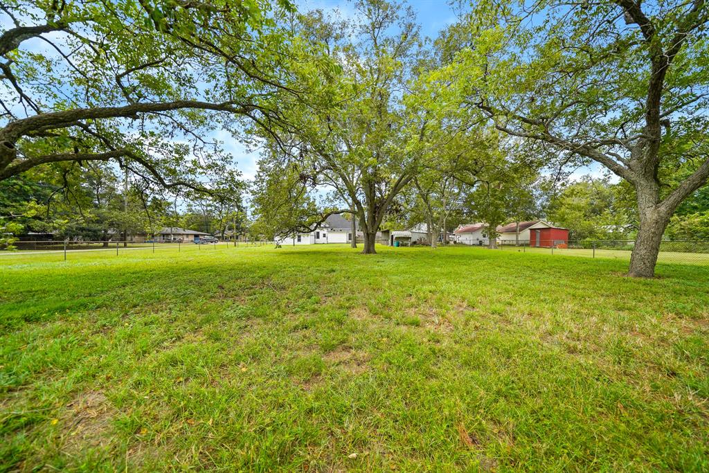 The Back Yard is fully fenced and can accommodate a large gathering. These majestic pecan trees add so much charm to the property, while also providing a desirable amount of shade.