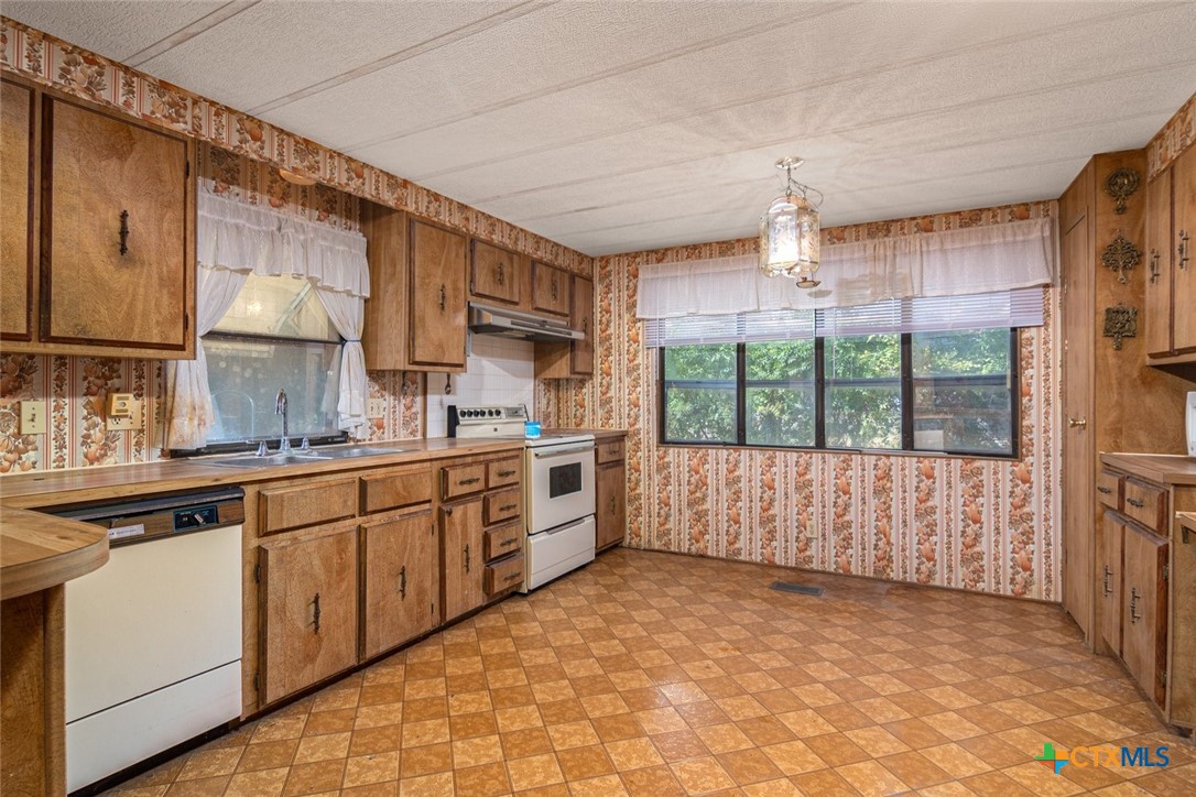 a large kitchen with a large window