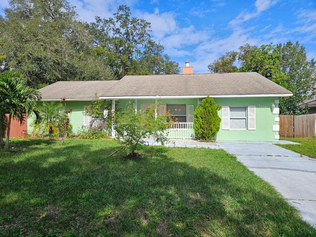 a view of a house with yard and a garden