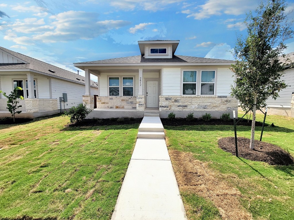 a front view of a house with a garden and patio