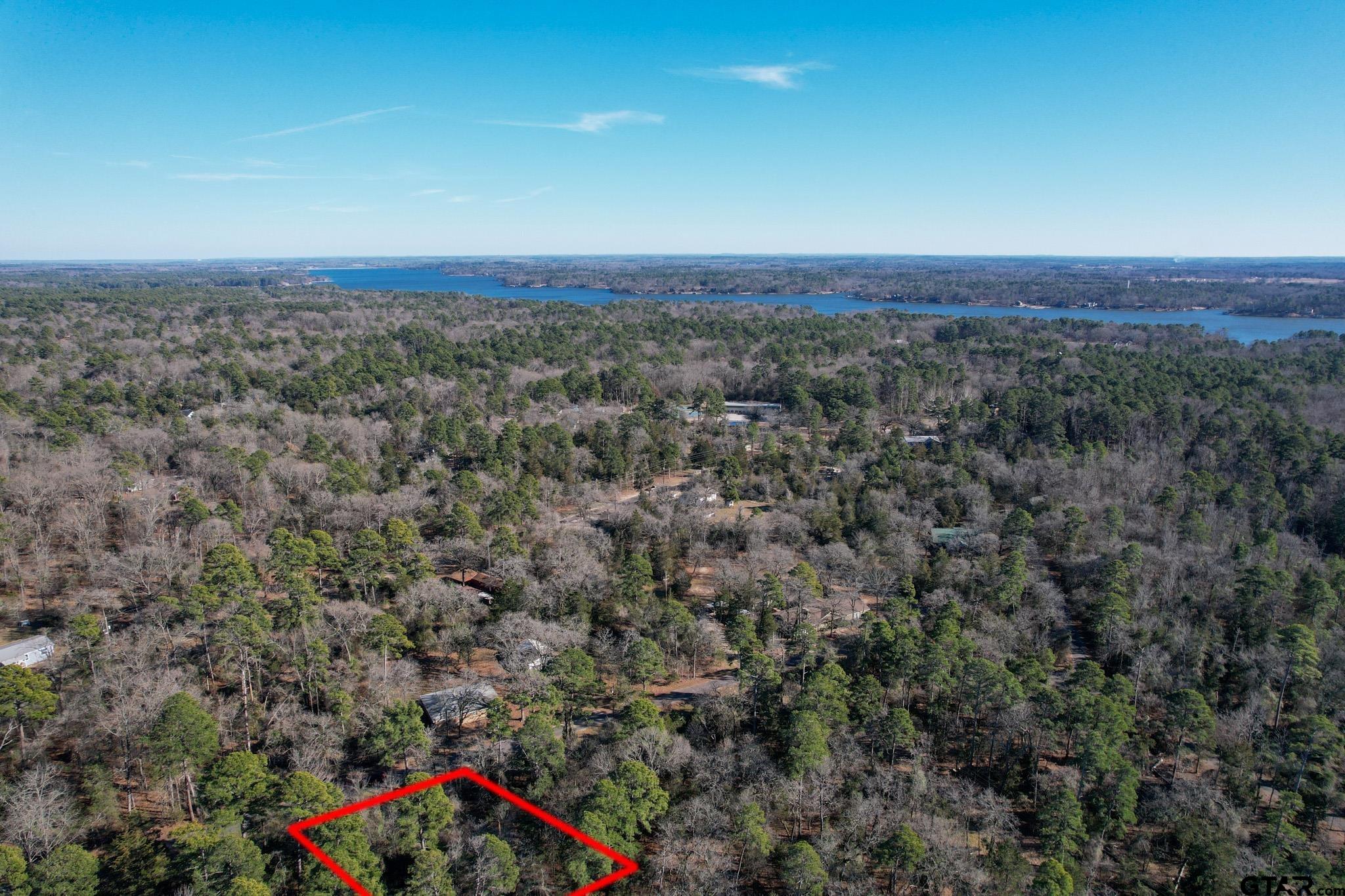 an aerial view of house with yard and mountain view in back