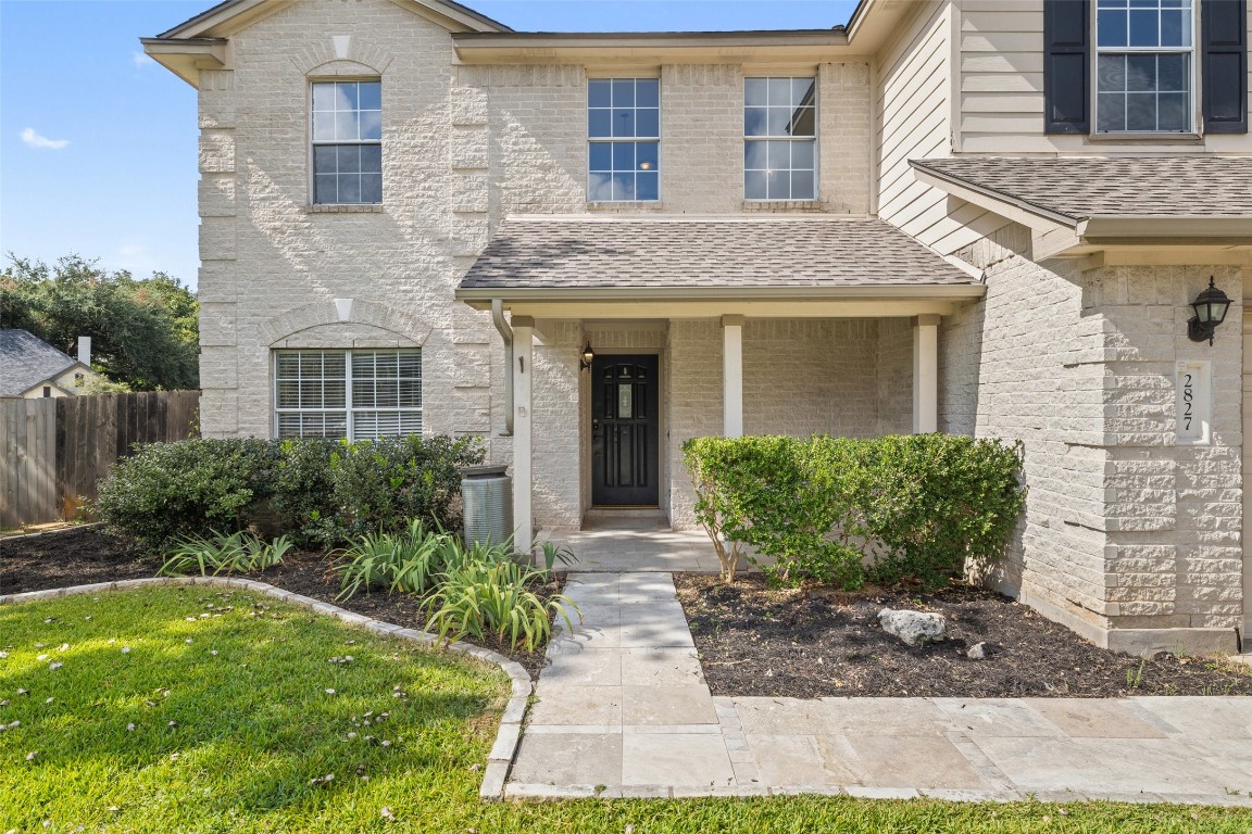 a front view of a house with garden