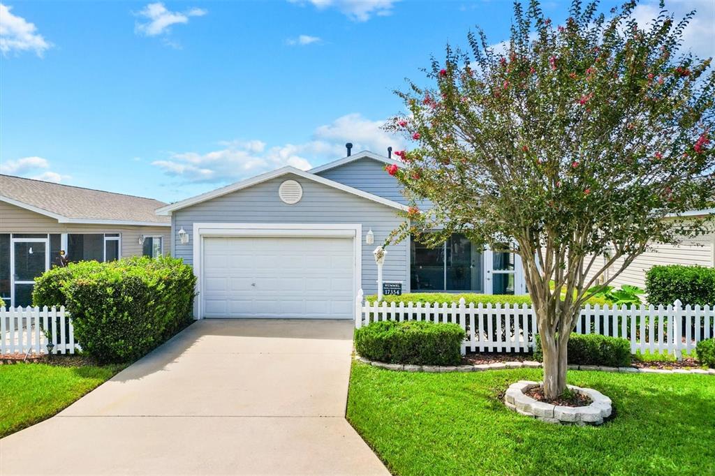 Neat as a pin with lovely mature crepe myrtle tree