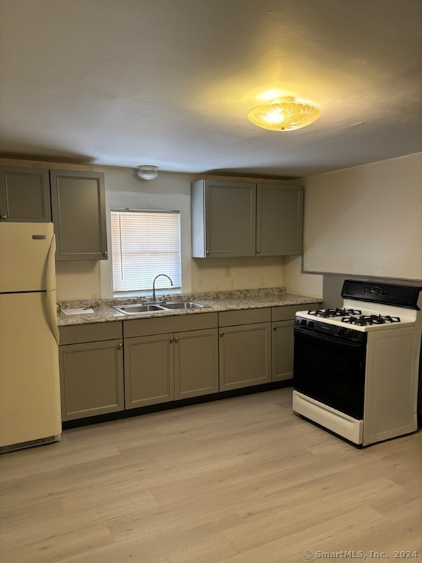 a kitchen with a sink a stove and cabinets