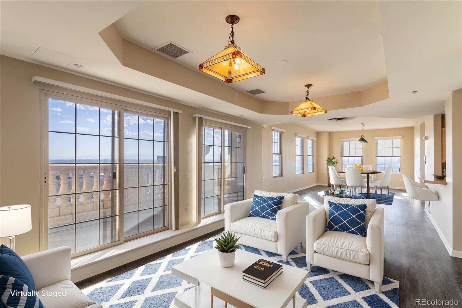 a living room with furniture a chandelier and a large window