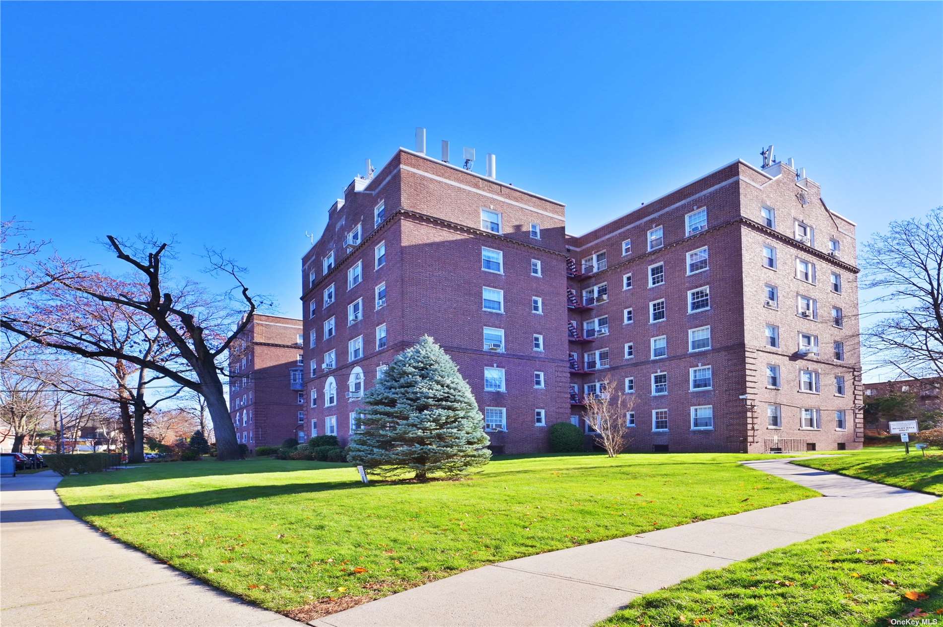 a backyard of a large building with large trees