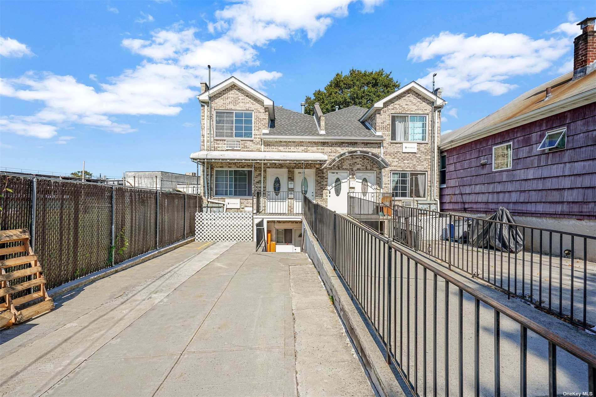 a view of a house with wooden fence