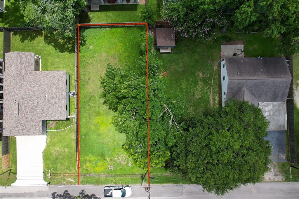 an aerial view of a house with a yard