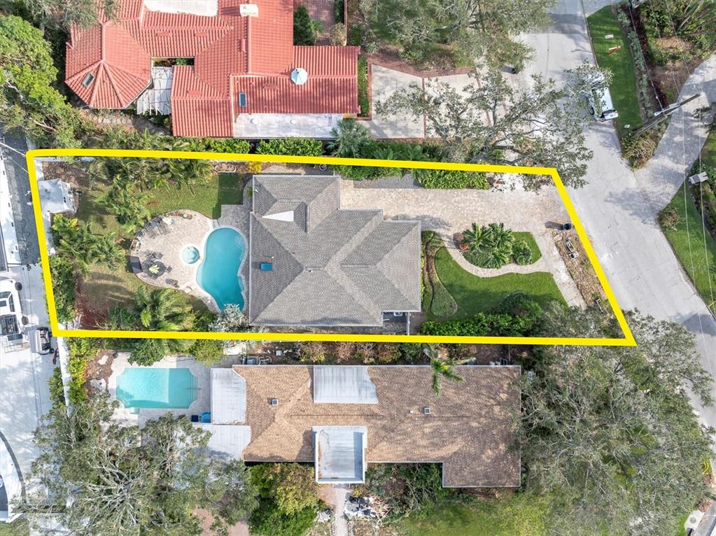 an aerial view of a swimming pool with outdoor seating