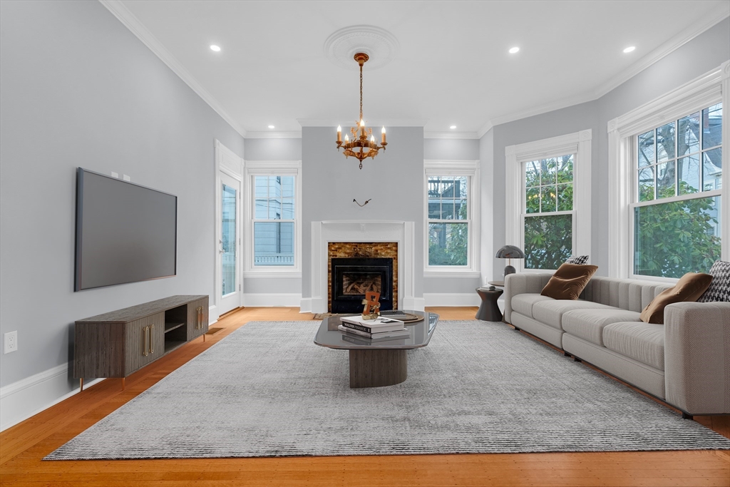 a living room with furniture a fireplace and a flat screen tv