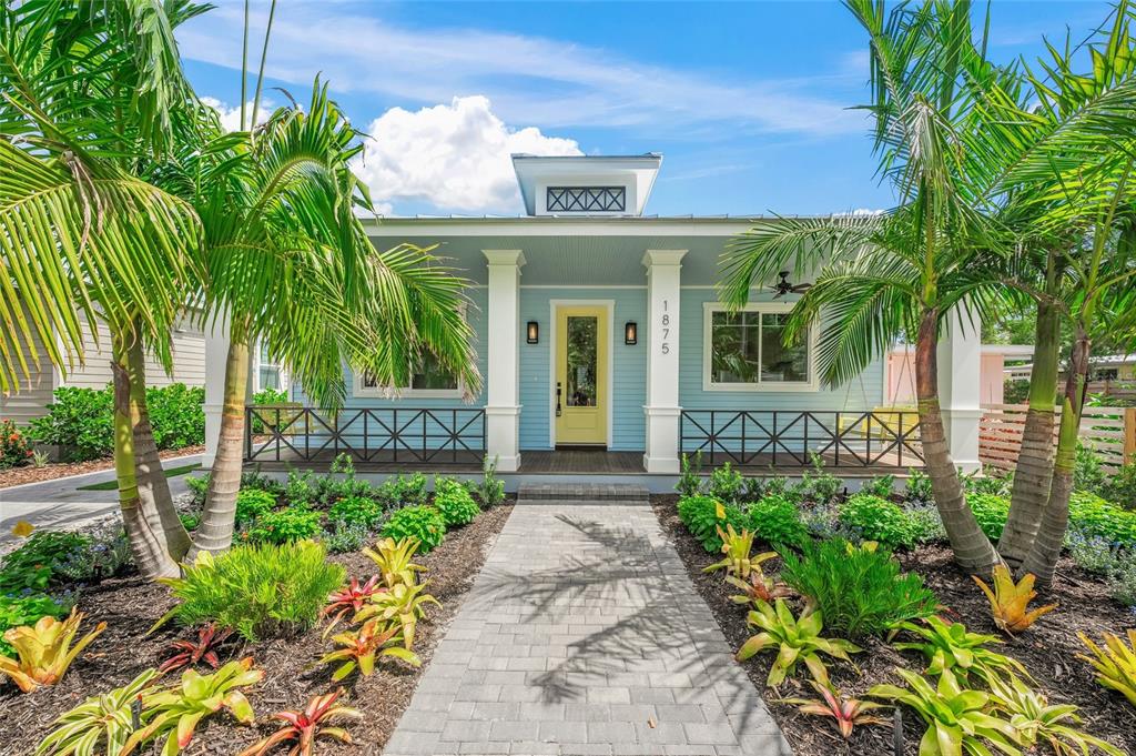 a front view of a house with a garden