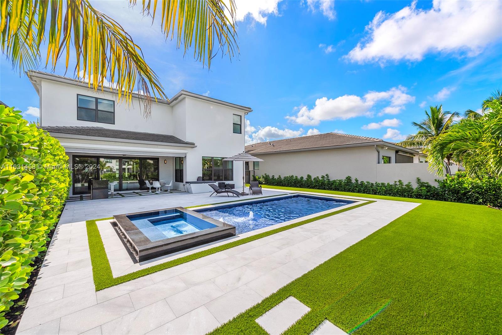 a view of a house with pool and a yard