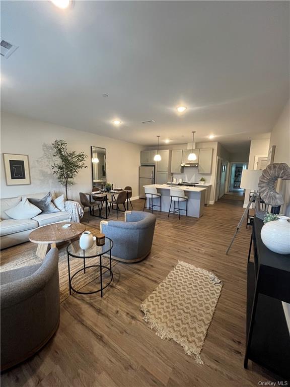 a living room with furniture kitchen view and a table