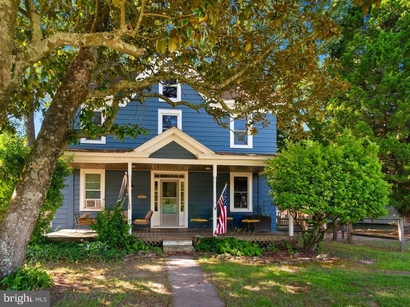 a front view of a house with yard and green space