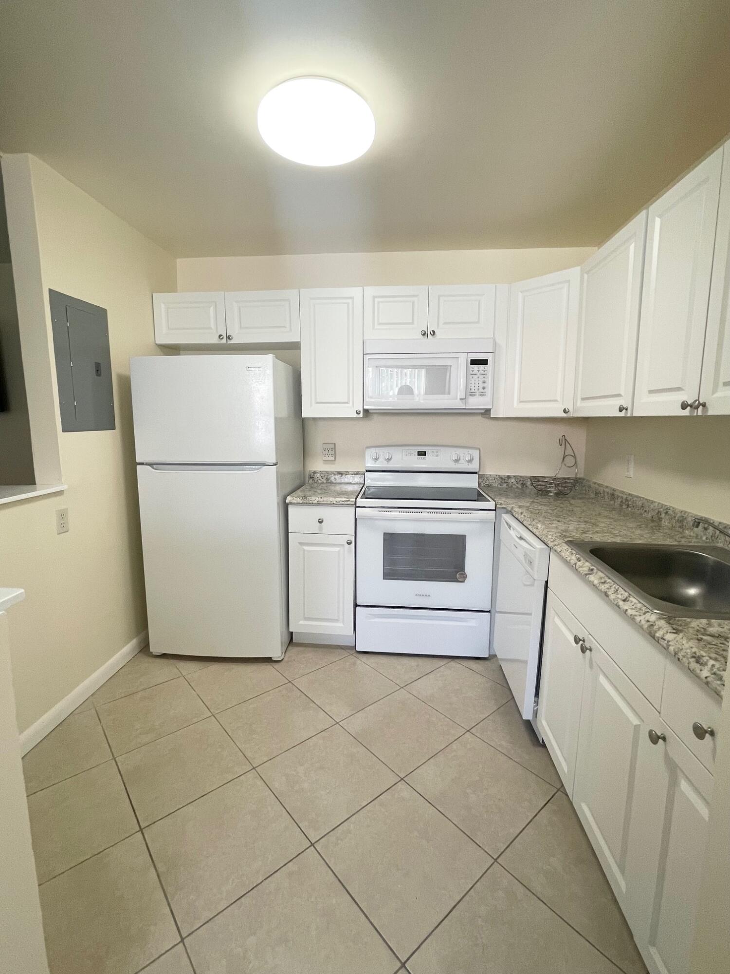 a kitchen with cabinets and white appliances