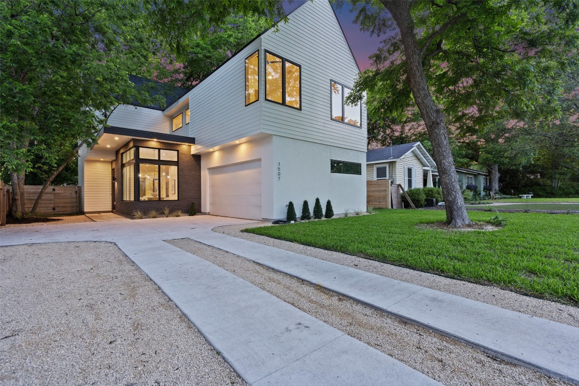 a front view of a house with a yard and garage