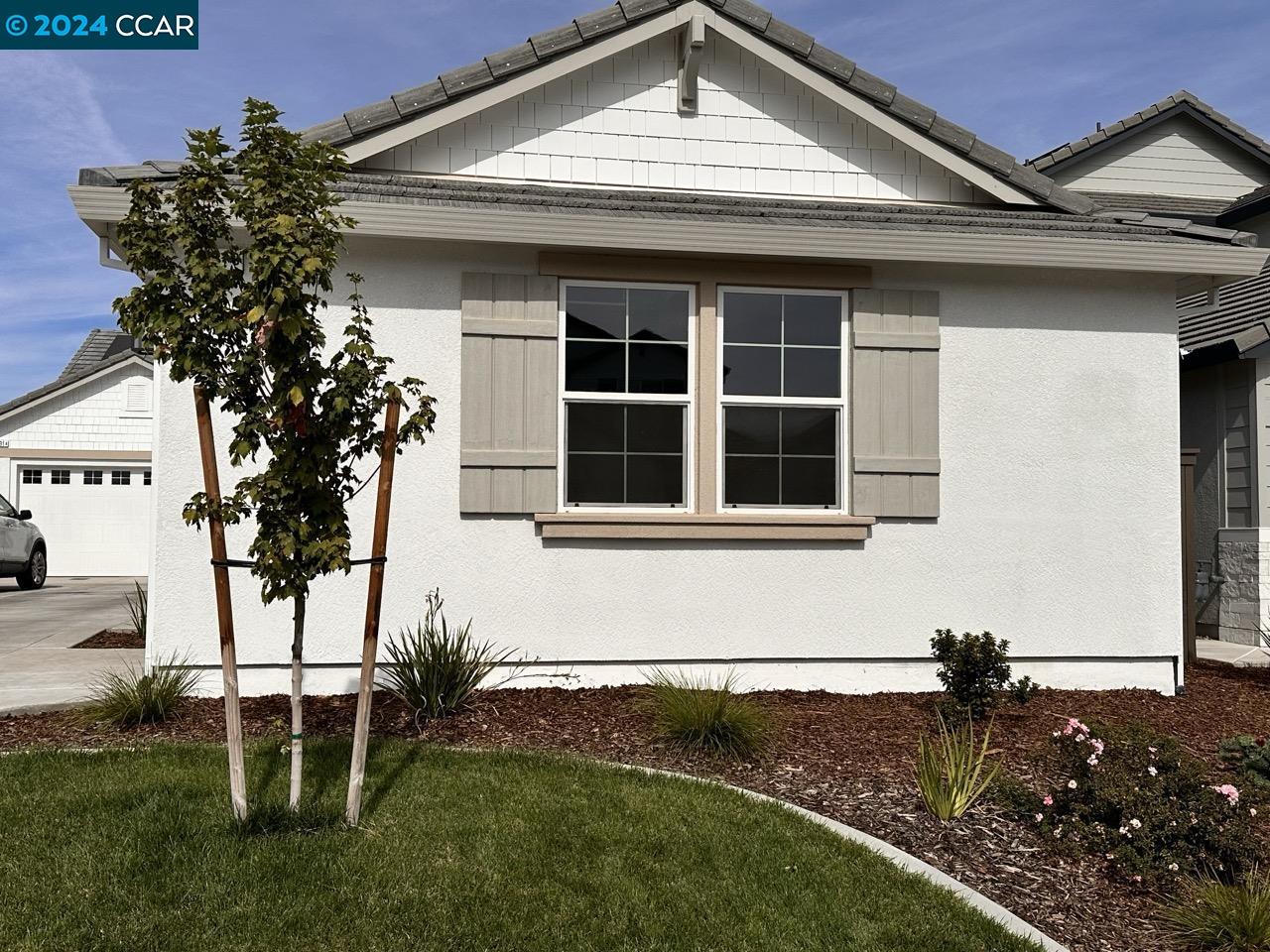 a front view of a house with a garden