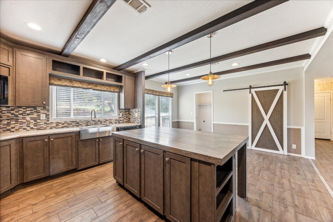 a kitchen with stainless steel appliances granite countertop a sink counter space and wooden floor