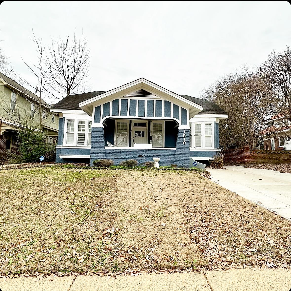 a front view of a house with a yard covered with snow