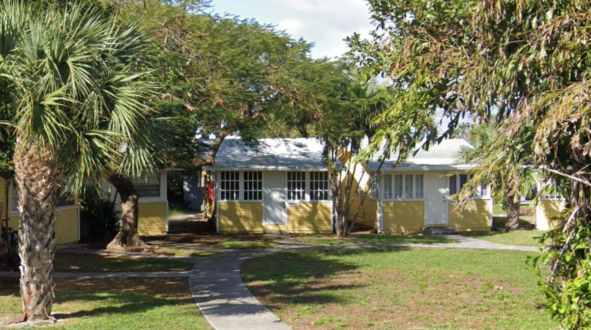 a view of a house with garden and trees