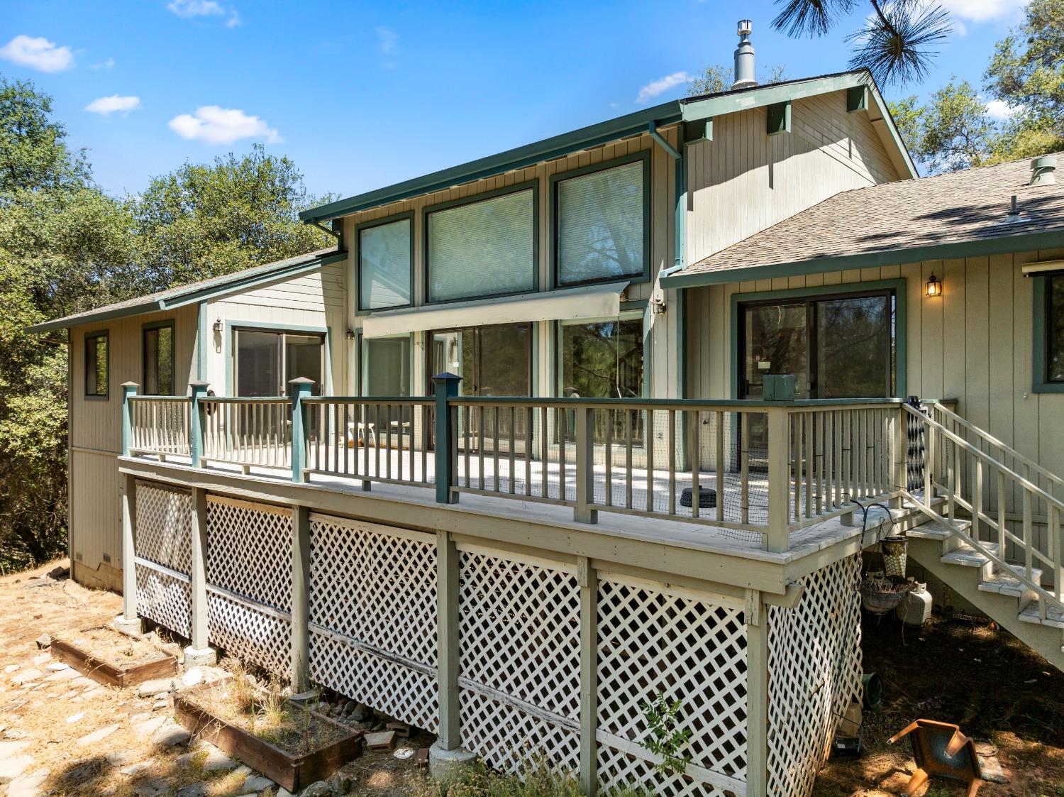 a view of a house with a wooden deck