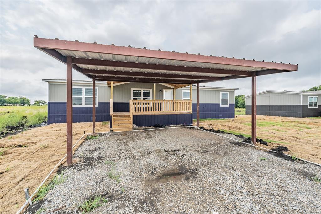 a view of a house with a wooden deck