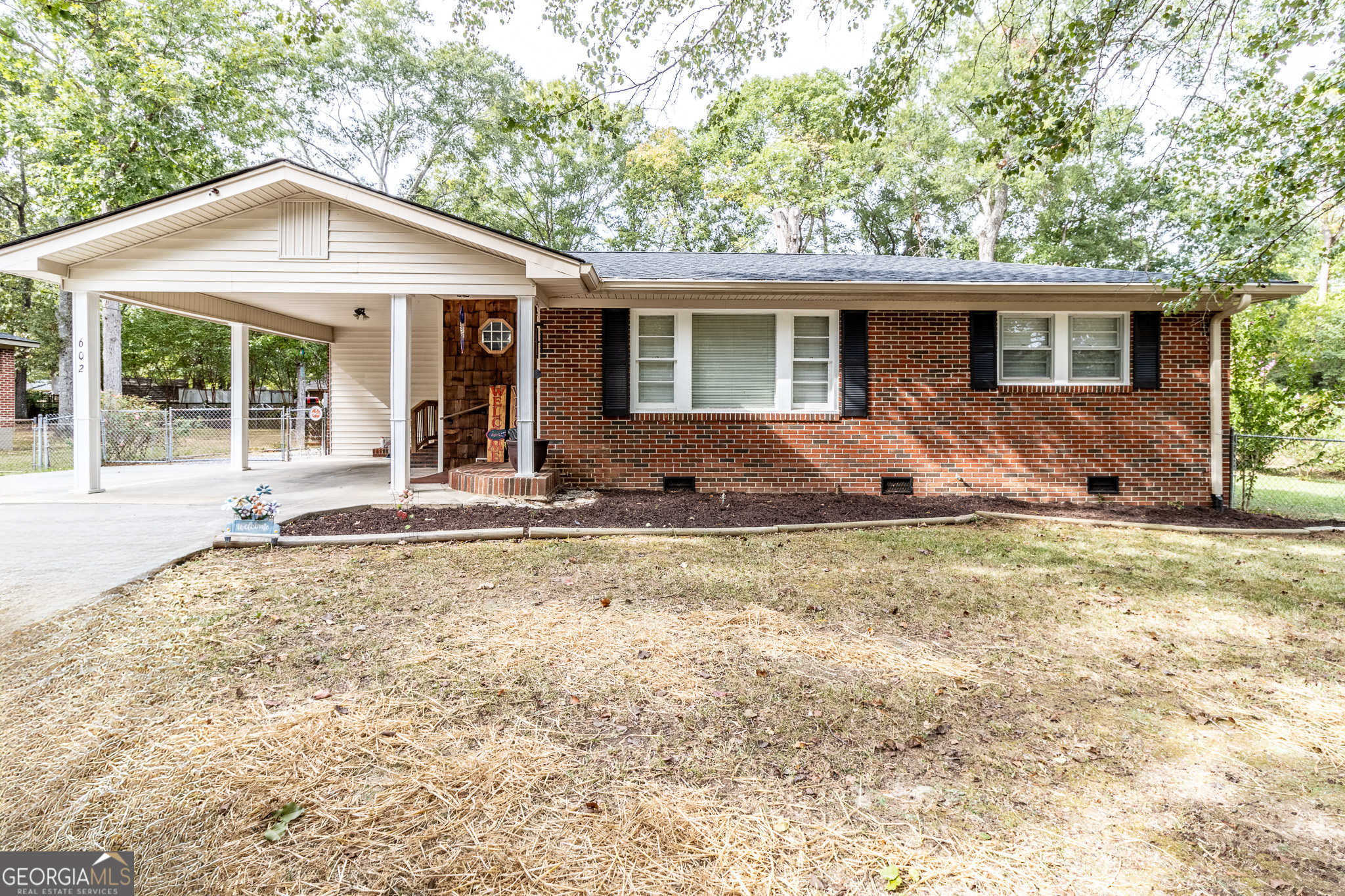 a front view of house with yard outdoor seating and barbeque oven