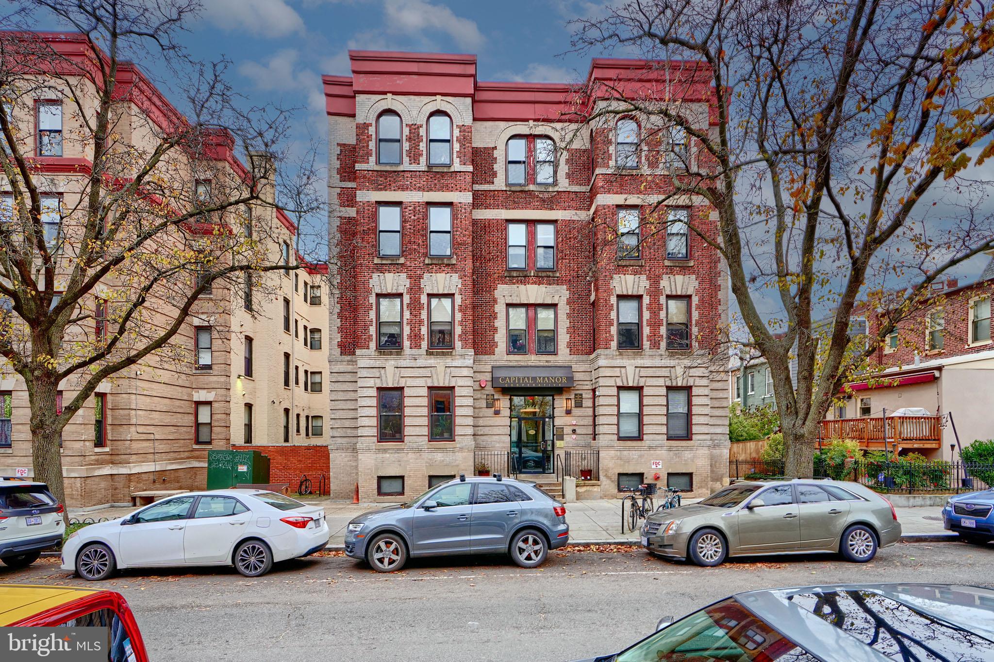 a buildings and cars parked in front of a building