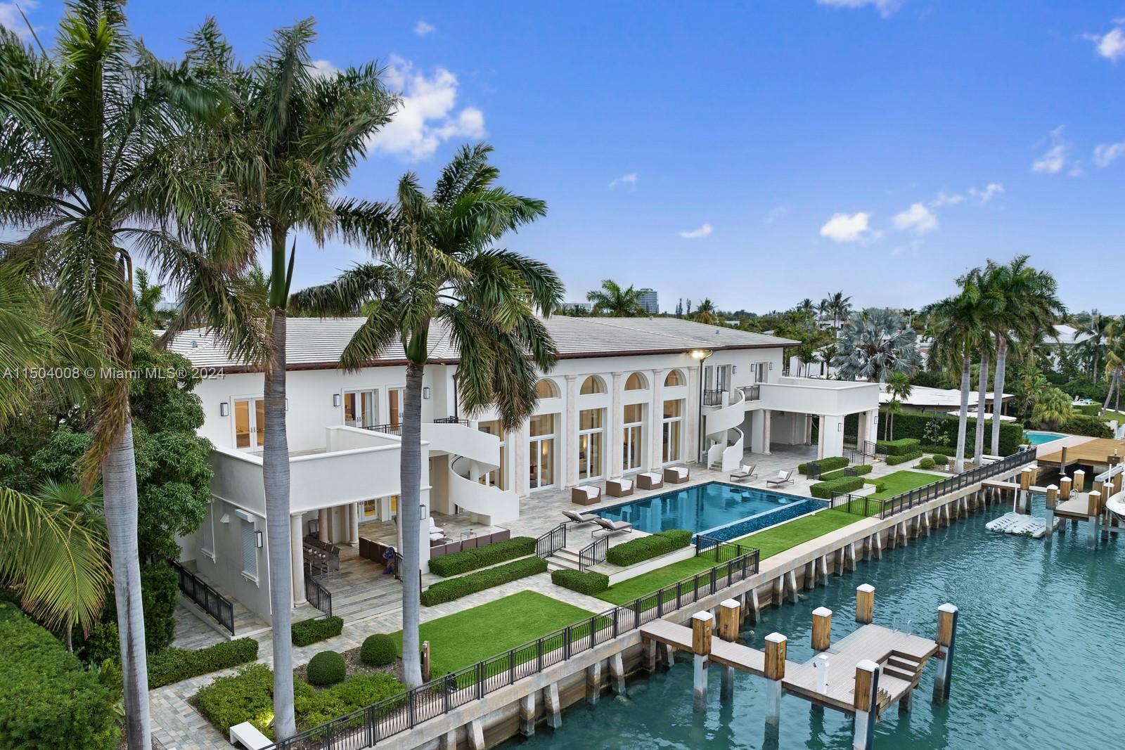 a view of a house with pool and chairs