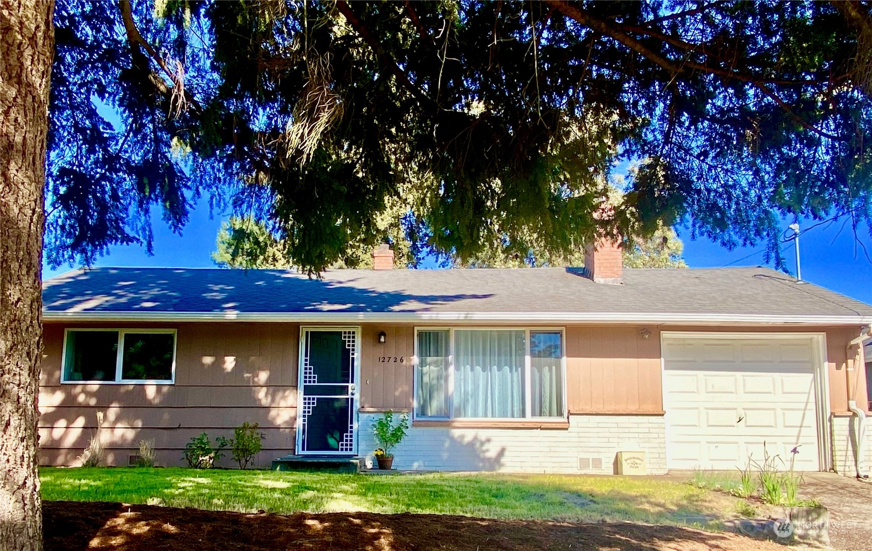 front view of a house with a yard