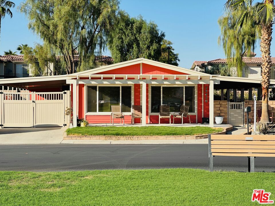 a front view of a house with a yard table and plants