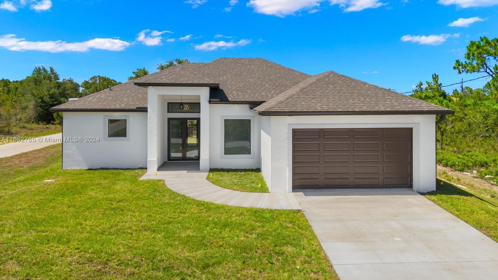 a front view of a house with a yard and garage