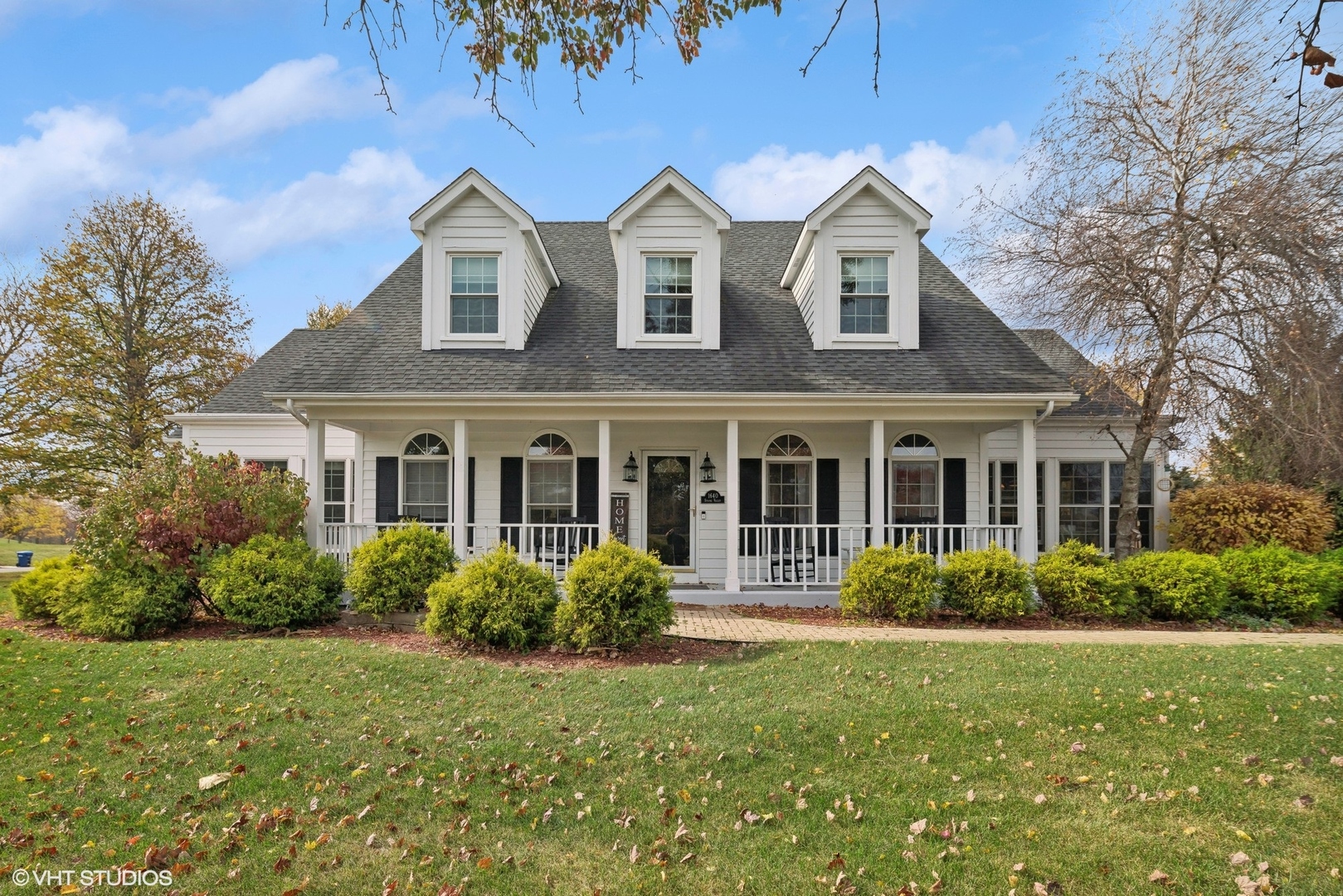 a front view of a house with garden and porch